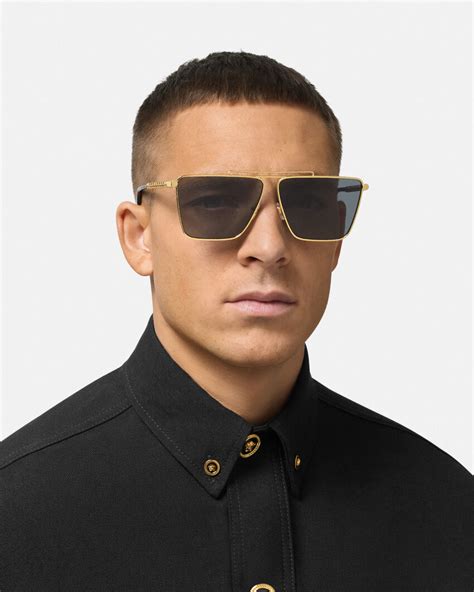 Versace: Gold Tubular Greca Sunglasses .